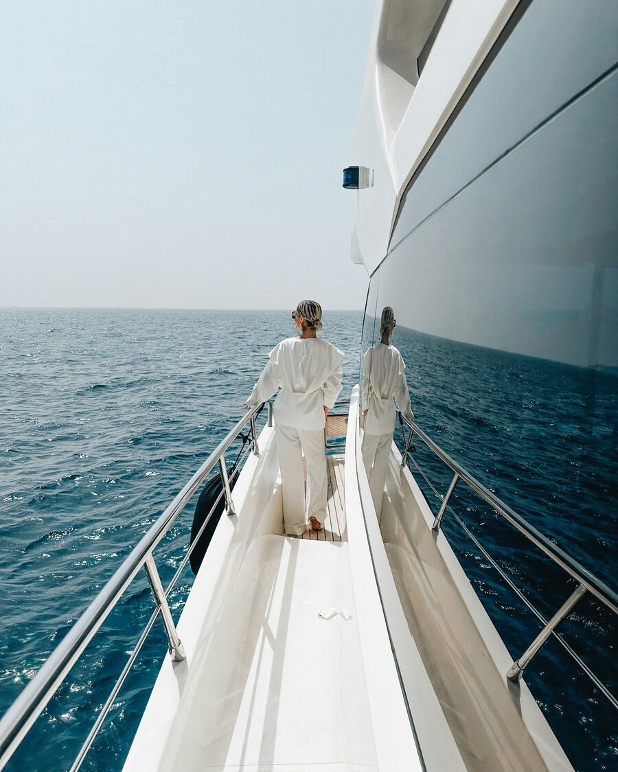 Owners walking the foredeck of a superyacht at sea