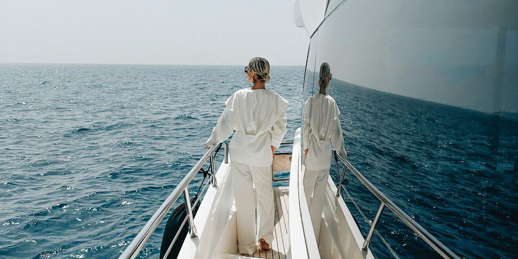 Owners walking the foredeck of a superyacht at sea